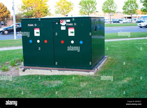 green electrical box on lawn|green electrical box in street.